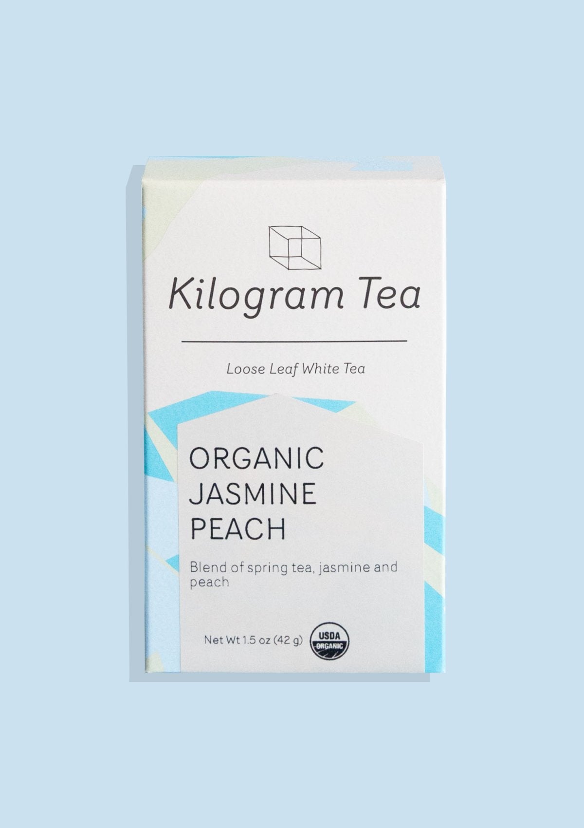 Kilogram Tea “Organic Jasmine Peach” loose-leaf white tea in blue packaging.
